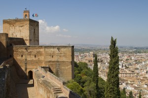The tall defensive towers of the Alhambra's Alcazaba dominate the surrounding plains...