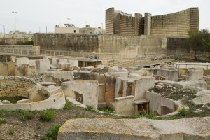 Looking over the walls of one of Tarxien's temples — try not to let that hideous church in the background distract you...