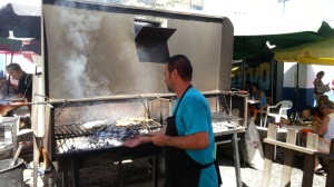 Grilling fresh fish at a local spot in Fuseta...
