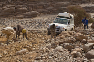Creeping down a boulder-filled wadi, rebuilding the road as we went...