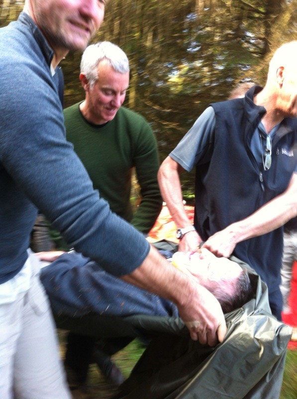 Evacuating a casualty on an improvised stretcher... He suddenly regained consciousness when I tried to steal his watch.