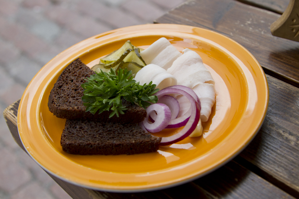 A typical Estonian starter... Smoked pork fat with pickles and onion, served on dark bread...